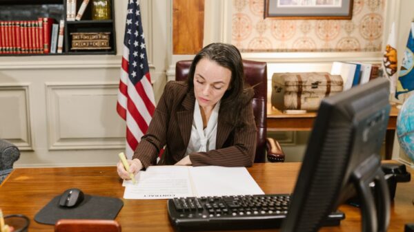 A woman writing on documents.
