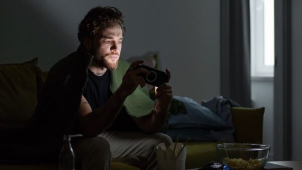 man playing a video game in the dark.