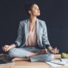 woman in business suit meditating.