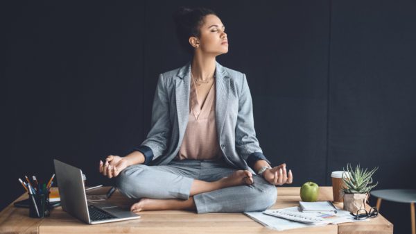 woman in business suit meditating.