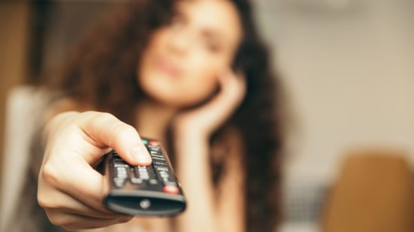 girl holding TV remote, Changing the channel