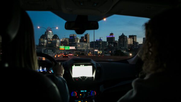 driving in a car, and a city is up ahead.