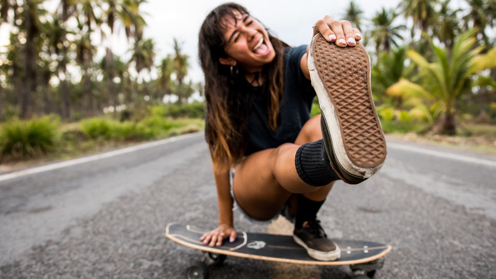 happy young woman on a skateboard.