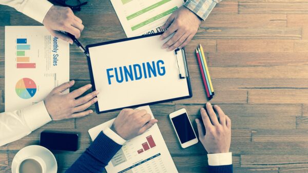 the word funding on a table with charts and graphs.