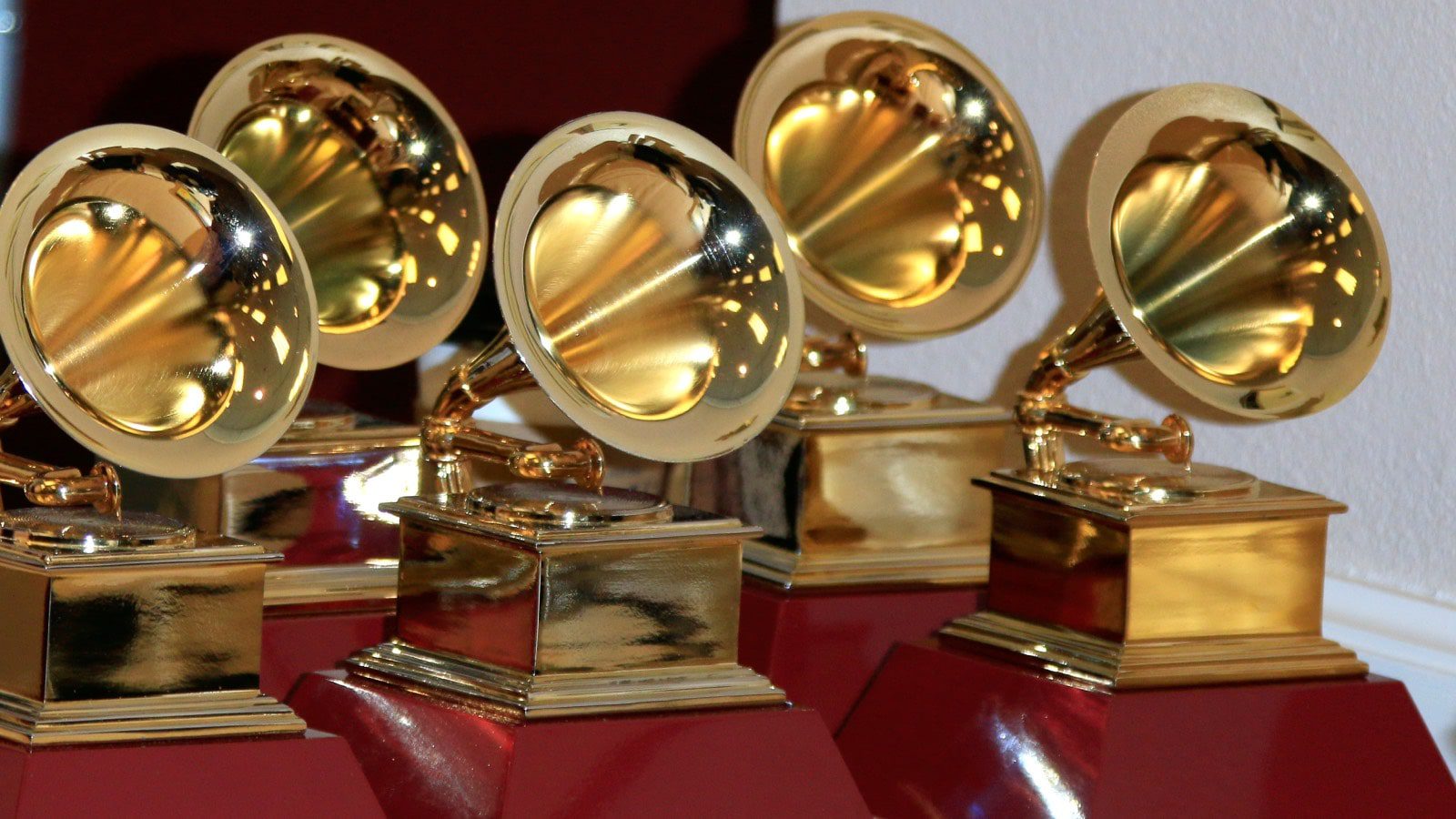 A table holding five Grammy trophies.