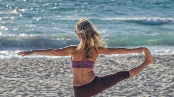 girl doing yoga on the beach.