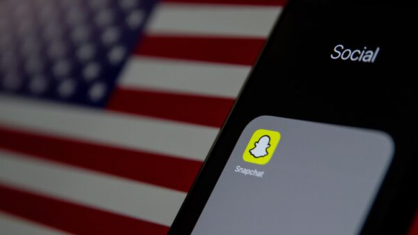 an iPhone with Snapchat pulled up in front of an American flag.