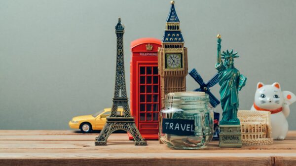 travel jar surrounded by figurines of monuments from around the world.