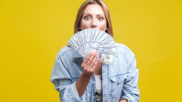 A woman fanning out hundred dollar bills.