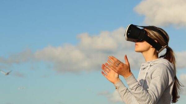 A woman using VR goggles outside.