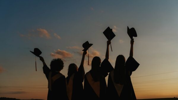 Graduates celebrating at sunset