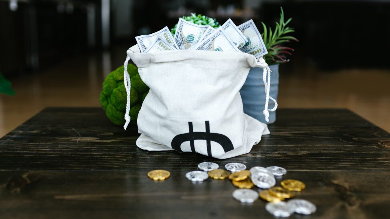 A bag of money on a table.