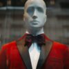A mannequin in a red tuxedo.