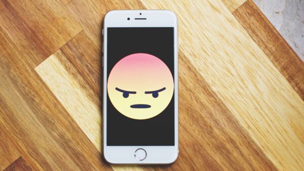 An angry emoji displayed on an iphone.