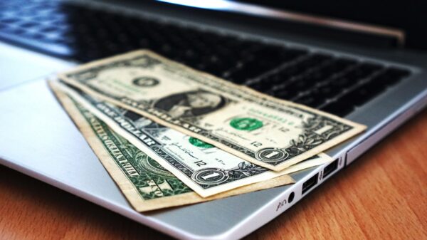 Money laying on a laptop.