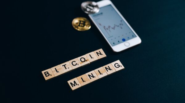 "Bitcoin mining" spelled with Scrabble tiles.