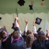 Graduates throwing up their caps.