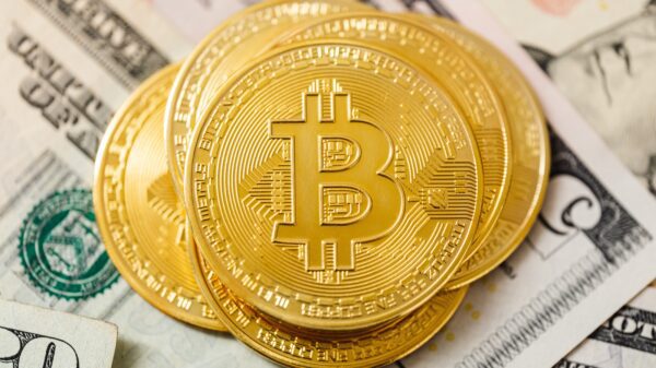Golden Bitcoins on top of cash.