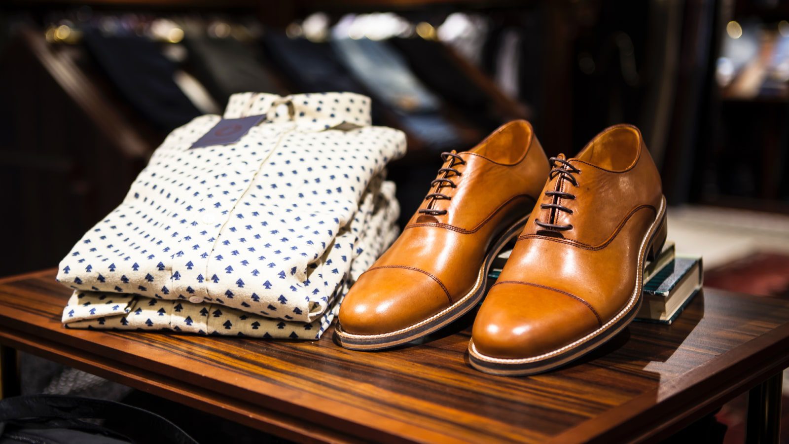 A pair of dress shoes and a button down shirt.