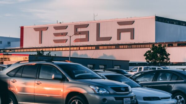 Cars parked in front of a Tesla building.