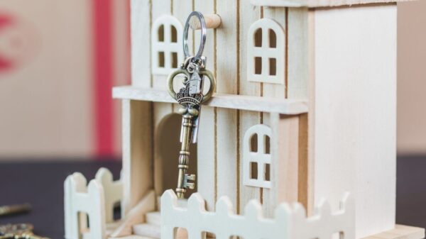 A skeleton key hanging on a doll house.