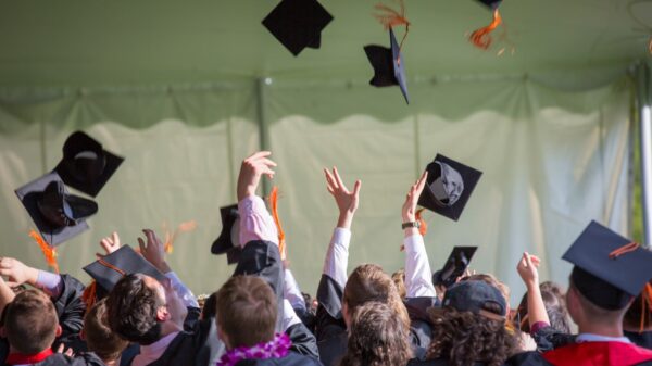 Graduates throwing their caps in the air.