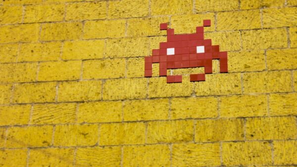 A Space Invader character on a brick wall.
