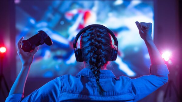 Girl with headphones playing video games.