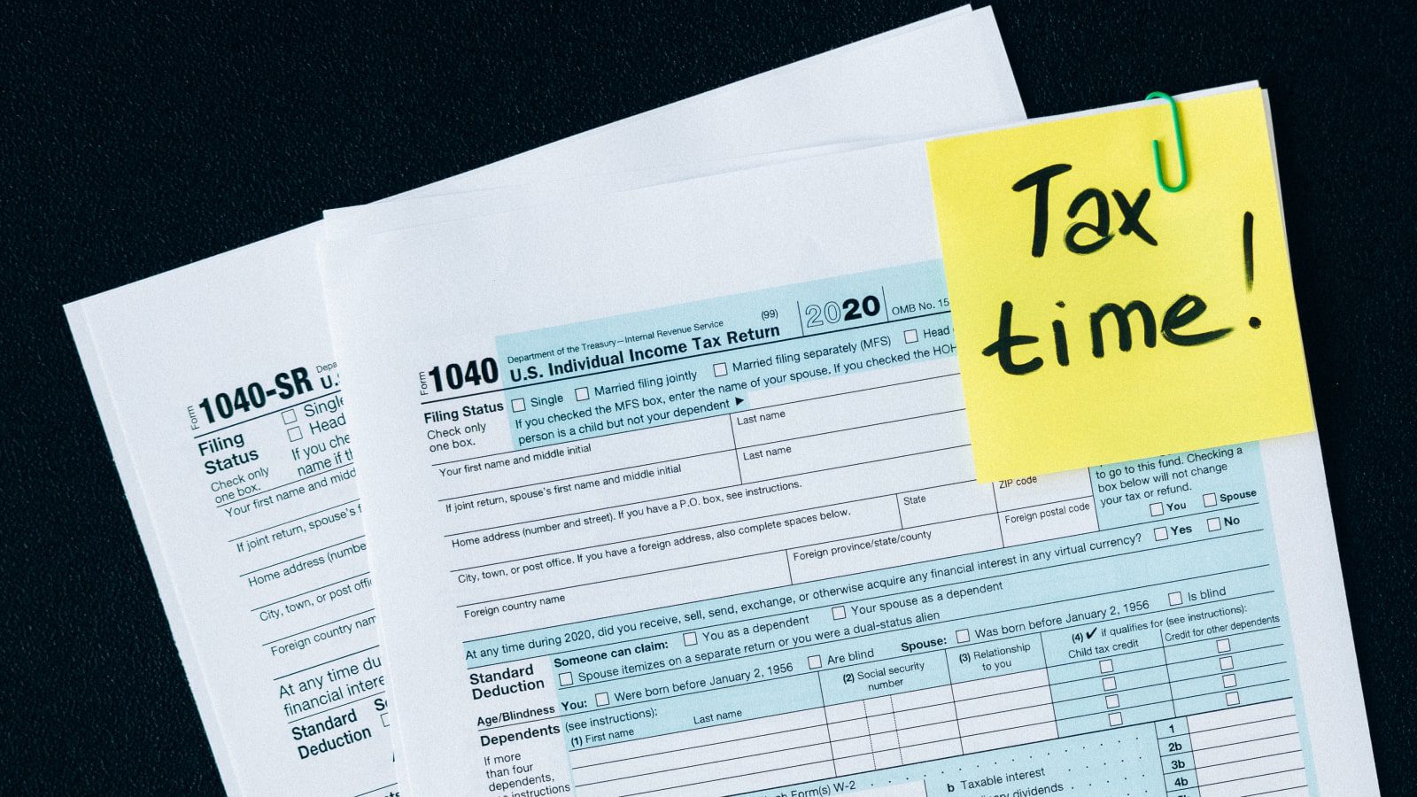 A tax document with a post-it note on top.