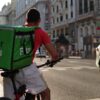 An Uber Eats delivery person on a bicycle.