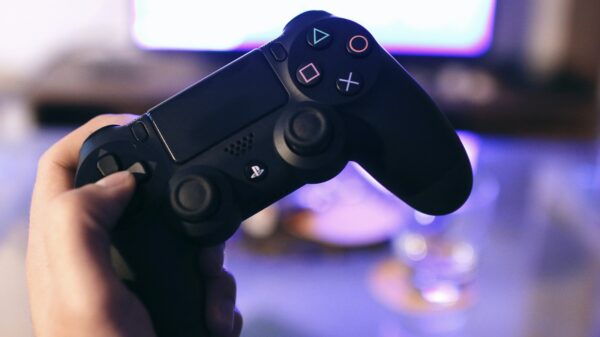 A person holding a dualshock 4 controller.