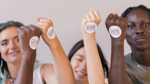 Young adults wearing vote stickers