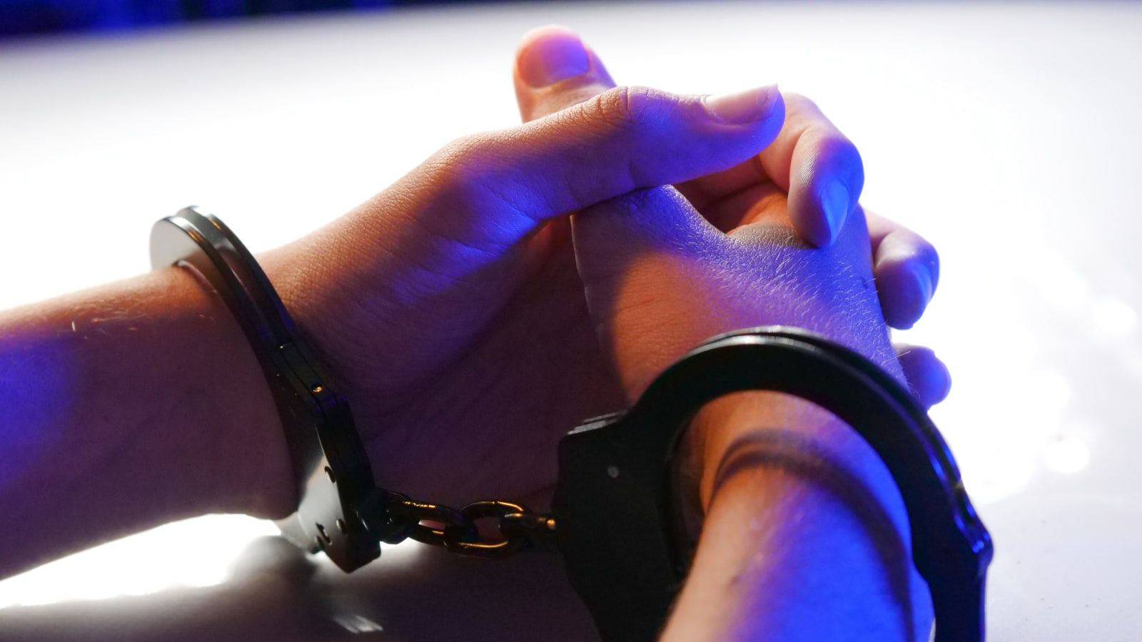 A pair of hands in handcuffs.