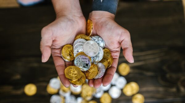 A person holding crypto coins.