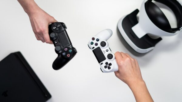 Two hands holding Dual Shock controllers.
