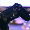 A person holding a Dualshock 4 controller.