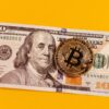 A bitcoin and a 100 dollar bill.