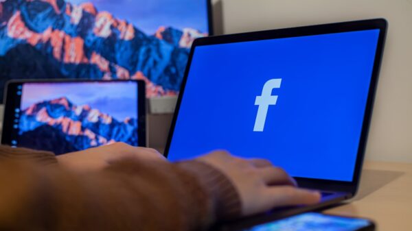 A laptop displaying Facebook's logo.
