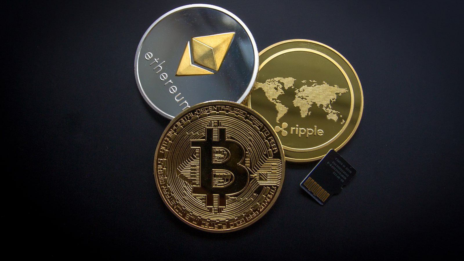 Bitcoin, Ripple. and Ethereum coins.