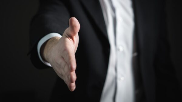 A businessman offering a handshake.