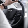 A person driving a Tesla.