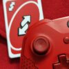 A red Xbox controller and Uno reverse card.