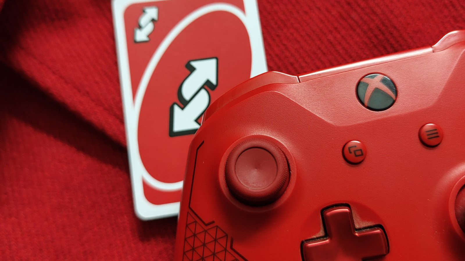 A red Xbox controller and Uno reverse card.