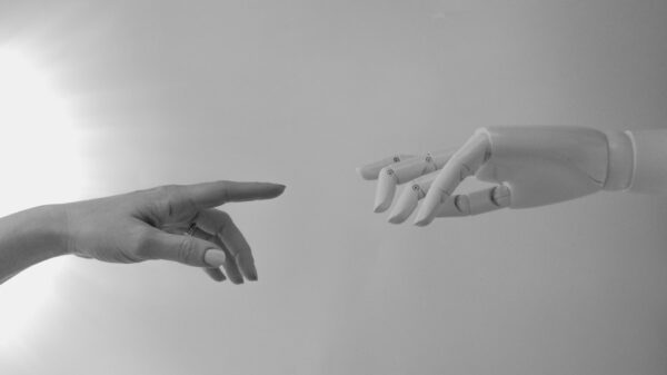 A human hand reaching for a robot hand.
