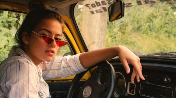 A young person behind the wheel of a car.