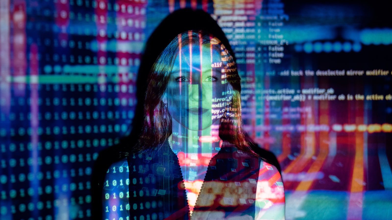 A woman with computer code projected over her.